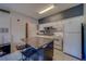 Functional kitchen featuring an island with seating, white cabinets, and essential appliances at 1240 S Missouri Ave # 415, Clearwater, FL 33756