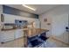 Practical kitchen featuring an island with seating, white cabinets, and essential appliances at 1240 S Missouri Ave # 415, Clearwater, FL 33756