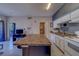 Well-equipped kitchen featuring a breakfast bar island, white appliances, and ample storage at 1240 S Missouri Ave # 415, Clearwater, FL 33756