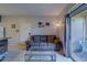 Cozy living room with a comfortable sofa, glass coffee table, and access to the patio at 1240 S Missouri Ave # 415, Clearwater, FL 33756