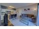 Open-concept living room and kitchen with white cabinets, breakfast bar, and comfortable seating at 1240 S Missouri Ave # 415, Clearwater, FL 33756