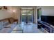 Inviting living room featuring a comfortable couch and sliding glass doors to the outside patio at 1240 S Missouri Ave # 415, Clearwater, FL 33756