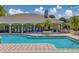 Inviting community pool with plenty of seating, palm trees and shaded area at 1240 S Missouri Ave # 415, Clearwater, FL 33756