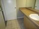 Bathroom view with vanity and sink with tile flooring. Doorway visible at 13289 Arbor Pointe Cir # 201, Tampa, FL 33617