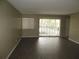 Spacious living room featuring sleek wood floors and abundant natural light at 13289 Arbor Pointe Cir # 201, Tampa, FL 33617