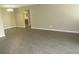 Large living space boasts modern flooring and a view into the bathroom at 13289 Arbor Pointe Cir # 201, Tampa, FL 33617