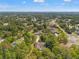 Aerial view of community with lush greenery, several homes, and roads between the subdivisions at 1379 Matthew Ave, Spring Hill, FL 34609