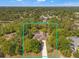 Aerial view of home surrounded by lush greenery, showcasing its peaceful setting at 1379 Matthew Ave, Spring Hill, FL 34609