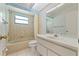 Cozy bathroom featuring a single vanity, toilet, and tub shower at 1379 Matthew Ave, Spring Hill, FL 34609
