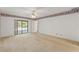 Bedroom with carpet, decorative wallpaper trim and sliding glass doors to pool at 1379 Matthew Ave, Spring Hill, FL 34609