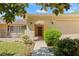 Inviting front entrance with an arched entryway and lush landscaping leading to the front door at 1379 Matthew Ave, Spring Hill, FL 34609