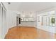 Spacious living room features wood floors and views into kitchen at 1379 Matthew Ave, Spring Hill, FL 34609