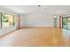 Spacious living room with hardwood floors, high ceilings, and a large window looking out to the yard at 1379 Matthew Ave, Spring Hill, FL 34609