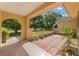 Outdoor patio featuring brick and tile flooring and a view of the landscaped yard at 1379 Matthew Ave, Spring Hill, FL 34609