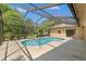 Beautiful screened-in pool set in lanai offers a delightful escape in a private backyard at 1379 Matthew Ave, Spring Hill, FL 34609