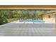Lovely screened-in pool in lanai with sparkling blue water provides refreshing spot to unwind at 1379 Matthew Ave, Spring Hill, FL 34609