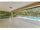 Relaxing view of the screened-in pool and lanai offers the perfect space for outdoor fun and relaxation at 1379 Matthew Ave, Spring Hill, FL 34609