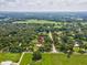 Discover the property from above, nestled within a scenic landscape of trees and open fields, offering a tranquil setting at 1414 Stephens Oak Ct, Plant City, FL 33567
