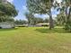 Picturesque backyard with a garage and lush lawn, perfect for outdoor activities at 1414 Stephens Oak Ct, Plant City, FL 33567