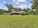 Lush green backyard with mature trees providing shade and privacy at 1414 Stephens Oak Ct, Plant City, FL 33567