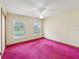 Bedroom with pink carpet, ceiling fan, and natural light from two windows at 1414 Stephens Oak Ct, Plant City, FL 33567