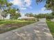 Expansive lot featuring lush greenery and a long concrete driveway leading to the home at 1414 Stephens Oak Ct, Plant City, FL 33567