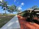 The exterior showcases a manicured lawn, mature landscaping, and well-kept sidewalk at 1414 Stephens Oak Ct, Plant City, FL 33567