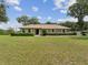 Well-maintained home with green lawn and tidy landscaping, creating a pleasant and inviting facade at 1414 Stephens Oak Ct, Plant City, FL 33567
