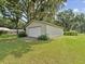 Large detached garage with white door, providing ample storage space at 1414 Stephens Oak Ct, Plant City, FL 33567