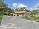 Detached two-car garage with a long driveway and well-manicured landscaping, adding convenience and curb appeal at 1414 Stephens Oak Ct, Plant City, FL 33567