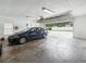 Spacious garage with a car and open garage door leading to the driveway at 1414 Stephens Oak Ct, Plant City, FL 33567