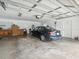 Spacious garage with a car, work bench, and ample storage space at 1414 Stephens Oak Ct, Plant City, FL 33567