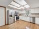Well-lit kitchen with stainless steel appliances, white cabinets, and a decorative ceiling light at 1414 Stephens Oak Ct, Plant City, FL 33567