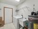 Functional laundry room with modern washer and dryer, utility sink, and water heater at 1414 Stephens Oak Ct, Plant City, FL 33567