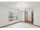 Bright living room featuring a large window, chandelier, and neutral carpet at 1414 Stephens Oak Ct, Plant City, FL 33567