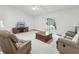 Bright living room featuring neutral carpet, ceiling fan, and sliding glass doors to the lanai at 1414 Stephens Oak Ct, Plant City, FL 33567