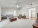 Open-concept living room with neutral carpet, ceiling fan, and views of the foyer at 1414 Stephens Oak Ct, Plant City, FL 33567