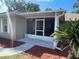 Inviting screened porch with a white screen door and sidewalk at 1414 Stephens Oak Ct, Plant City, FL 33567