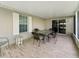 Spacious screened porch with neutral tile flooring and outdoor seating at 1414 Stephens Oak Ct, Plant City, FL 33567