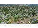 Aerial view showcasing the neighborhood, lush greenery, and proximity to the city skyline and a nearby bridge at 1432 S Keene Rd, Clearwater, FL 33756