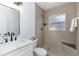 Updated bathroom features a modern vanity, stylish fixtures, and a tiled shower with a built-in bench at 1432 S Keene Rd, Clearwater, FL 33756