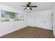 Charming bedroom with wood-look flooring, a ceiling fan, and natural light at 1432 S Keene Rd, Clearwater, FL 33756