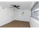 Neutral bedroom with a ceiling fan, fresh white walls, and bright natural light at 1432 S Keene Rd, Clearwater, FL 33756