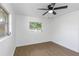 Bedroom featuring wood-look flooring, ceiling fan, and bright natural light at 1432 S Keene Rd, Clearwater, FL 33756