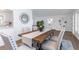 Dining room with wood table, light gray chairs, and a geometric decor mirror at 1432 S Keene Rd, Clearwater, FL 33756