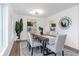 Well decorated dining room with wood table, light gray chairs, and modern chandelier at 1432 S Keene Rd, Clearwater, FL 33756