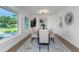 Dining room with a wooden table, gray chairs, and a modern light fixture at 1432 S Keene Rd, Clearwater, FL 33756
