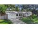 Charming one-story home featuring an attached garage, well-maintained lawn, and a welcoming front entrance at 1432 S Keene Rd, Clearwater, FL 33756