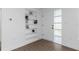 A clean and bright foyer with wood-look floors and a built in shelving unit at 1432 S Keene Rd, Clearwater, FL 33756