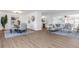 Bright, open-concept living space with modern furnishings and wood-look flooring at 1432 S Keene Rd, Clearwater, FL 33756